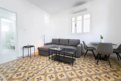 a living room with a couch and a table and chairs at Limassol Centr Apartament in Limassol