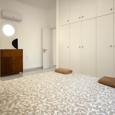 a bedroom with a large bed and a dresser at Limassol Centr Apartament in Limassol