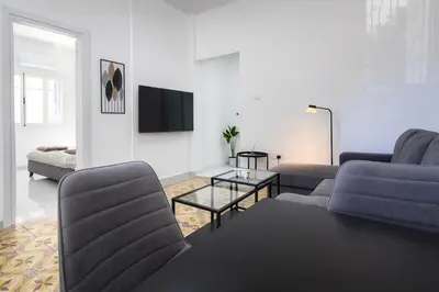 a living room with two couches and a tv at Limassol Centr Apartament in Limassol