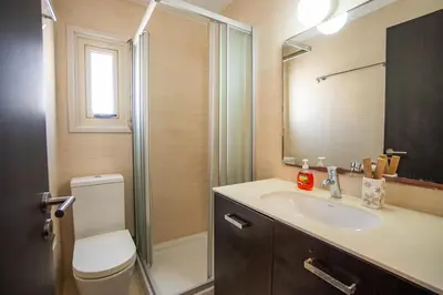 a bathroom with a toilet and a sink and a shower at Beachfront Villa Larnaka Dhekelia with Pool in Pyla