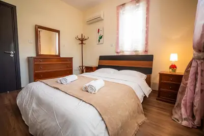 a bedroom with two white towels on a bed at Beachfront Villa Larnaka Dhekelia with Pool in Pyla