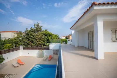 a balcony with a swimming pool on a house at Beachfront Villa Larnaka Dhekelia with Pool in Pyla