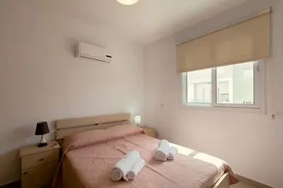 a bedroom with a bed with two towels on it at Obv 2304 in Pyla