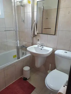 a bathroom with a sink and a toilet and a shower at Blue Boutique Flat in Larnaka