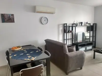a living room with a chair and a table at Oceania Bay Residence in Pyla