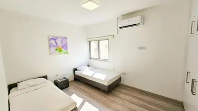 a room with two beds and a window at Blue Sky Ocean Retreat in Larnaka