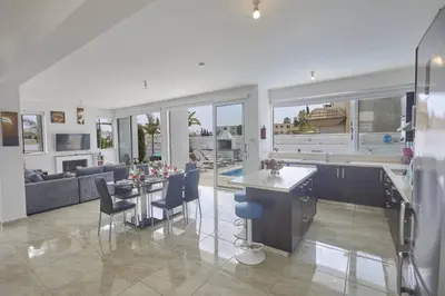 a kitchen and living room with a table and chairs at Protaras Pearl Villa Pe15 in Protaras