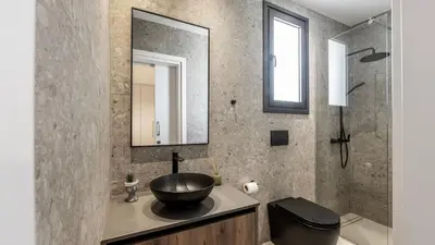 a bathroom with a bowl sink and a mirror at Nissi Residences Villa 4 in Ayia Napa
