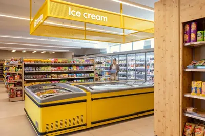 a store aisle with a ice cream counter in a store at SUNWING Sandy Bay Beach Village in Ayia Napa
