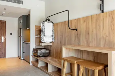 a kitchen with a counter and wooden walls at SUNWING Sandy Bay Beach Village in Ayia Napa