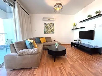 a living room with a couch and a table at One Bedroom Flat in Central Nicosia in Nicosia