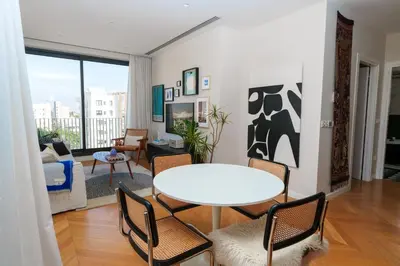 a living room with a table and chairs at Penthouse Living in the Heart of Nicosia in Nicosia