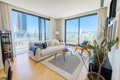 a living room with a couch and large windows at Penthouse Living in the Heart of Nicosia in Nicosia