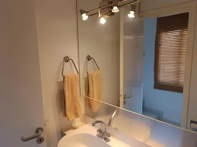 a bathroom with a sink and a large mirror at Sea view Beach House with Pool in Limassol