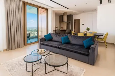 a living room with a couch and two tables at 360 Sky Residence, Gym & Pool - 26th Floor in Nicosia