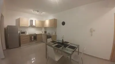 a kitchen with a table and a dining room at Emerald Heights in Tersephanou