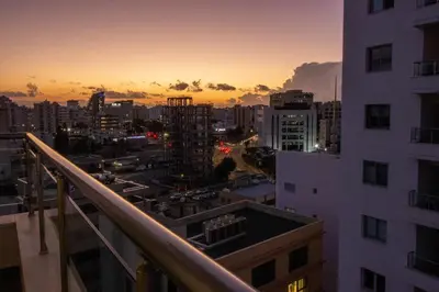 a view of a city at sunset from a building at Top Floor Gem: 3BR, Huge Veranda in Nicosia