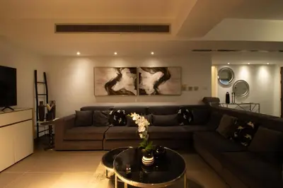 a living room with a couch and a table at Top Floor Gem: 3BR, Huge Veranda in Nicosia