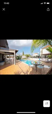 a picture of a pool with a table and chairs at Villa 4 Ayia Thekla in Ayia Napa