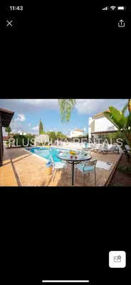 a picture of a pool with a table and chairs at Villa 4 Ayia Thekla in Ayia Napa