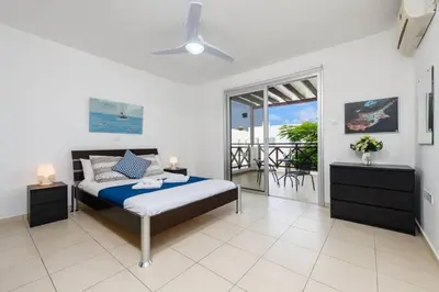 a bedroom with a bed and a balcony at Konnos Breeze Villa in Protaras