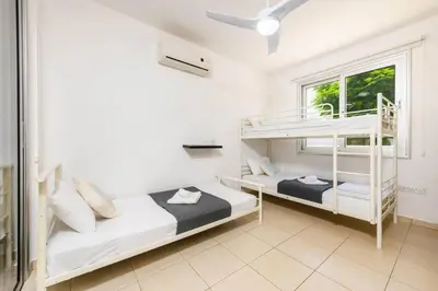 a bedroom with two bunk beds and a window at Konnos Breeze Villa in Protaras
