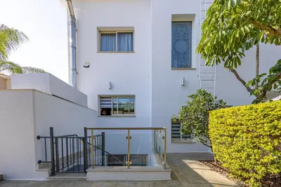 a white house with a staircase in front of it at Agios Tychon Luxury Villa with Private Pool in Limassol
