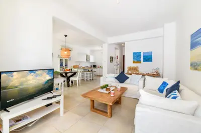 a living room with a white couch and a tv at Villa Atlantis in Protaras