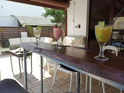 three cocktails sitting on a table on a patio at Casa Palmera in Paralimni