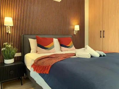 a bedroom with a large bed with colorful pillows at Beautiful One Bedroom Apartment 100 Meters from the Beach, Recently Renovated in Limassol