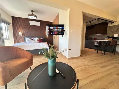 a living room with a bed and a table in a room at Beautiful One Bedroom Apartment 100 Meters from the Beach, Recently Renovated in Limassol