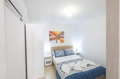 a small bedroom with a bed and a painting on the wall at Mylos Villas in Protaras