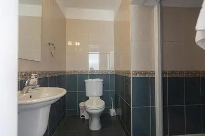 a bathroom with a toilet and a sink and a shower at Mylos Villas in Protaras