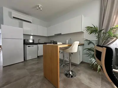 a kitchen with a counter and a white refrigerator at Your place for relax in Larnaka