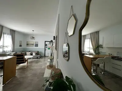 a living room with a large mirror on the wall at Your place for relax in Larnaka
