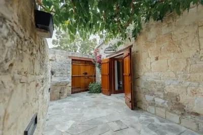 an entrance to a stone building with a wooden door at The Yard Traditional Residence in Vasa Kilaniou