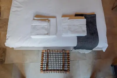 an overhead view of a bathroom with towels and a grate at The Yard Traditional Residence in Vasa Kilaniou