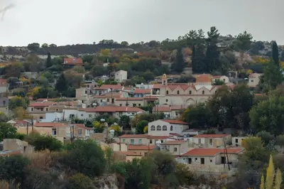a group of houses on a hill with trees at The Yard Traditional Residence in Vasa Kilaniou