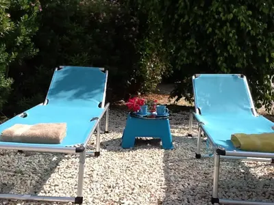 two beds and a table in the sand at Pissouri Beach House - Image in Pissouri
