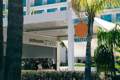 a store with a sign in front of a building at SunnyVillas 1 Bedroom Swimming Pool COR in Protaras
