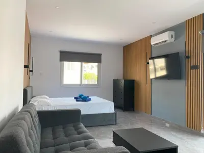 a living room with a bed and a couch at Nissi Avenue Studios in Ayia Napa
