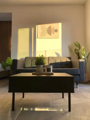 a living room with couches and a coffee table at Nissi Avenue Studios in Ayia Napa