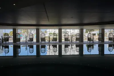 a row of chairs in a building with a pool of water at The HEALTHY Stay-Padel, Pool&Fitness in Ayia Napa
