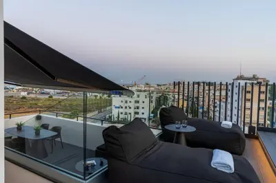 a balcony with two couches and tables on a building at The Penthouse - 3BR Seaview with Private Pool in Larnaca in Larnaka