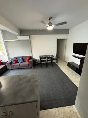 a living room with a couch and a table at Georges 2 Bedroom Apartment in Limassol