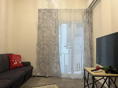 a living room with a couch and a window at 1 room apartment on the 1st line in Limassol