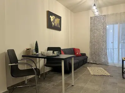 a living room with a table and a couch at 1 room apartment on the 1st line in Limassol
