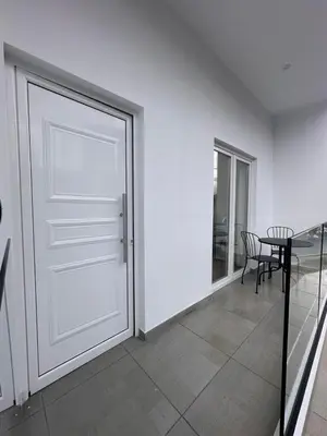a room with a door and a table and chair at Joanna's Rooms in Kalopanayiotis