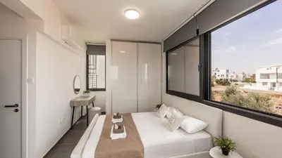 a room with a bed and a large window at Villa Iva by the Sea in Paralimni