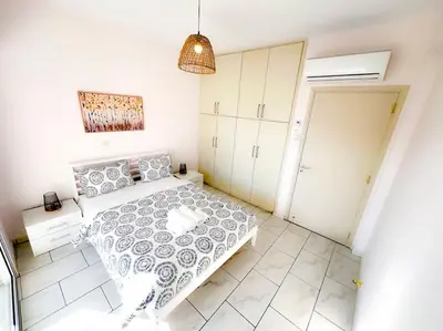 a small bedroom with a bed and a closet at Samos City Center, 2BR Sleeps 4 in Limassol